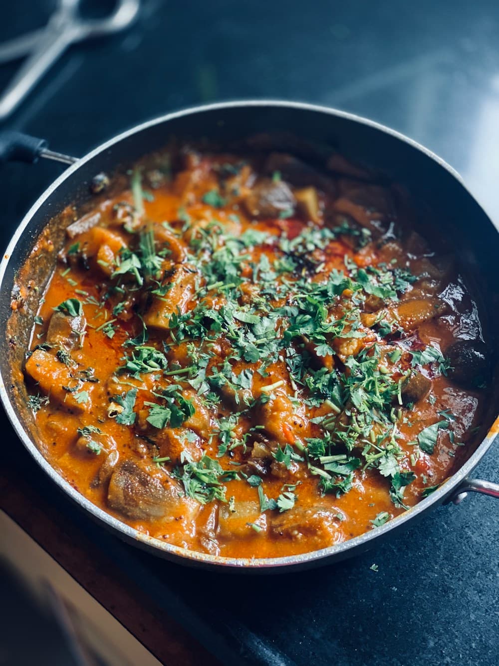 Curry with fresh coriander in a pan